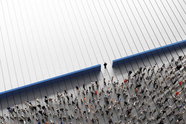 Man walking an opening in a wall