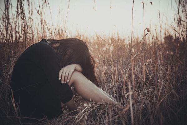Portrait of lonely woman alone in a field vintage