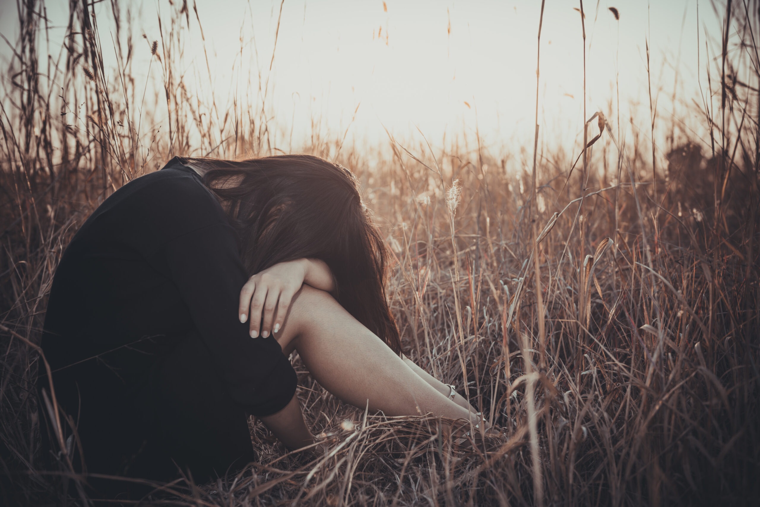 Portrait of lonely woman alone in a field vintage