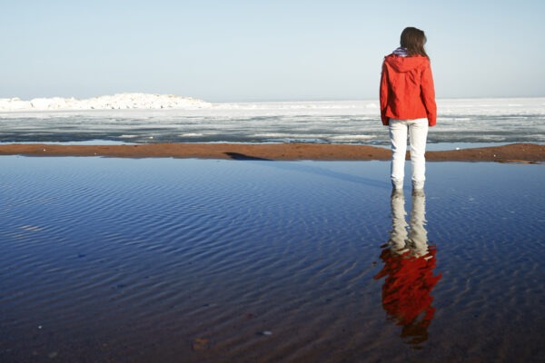 Young adult woman outdoors enjoying icy landscape
