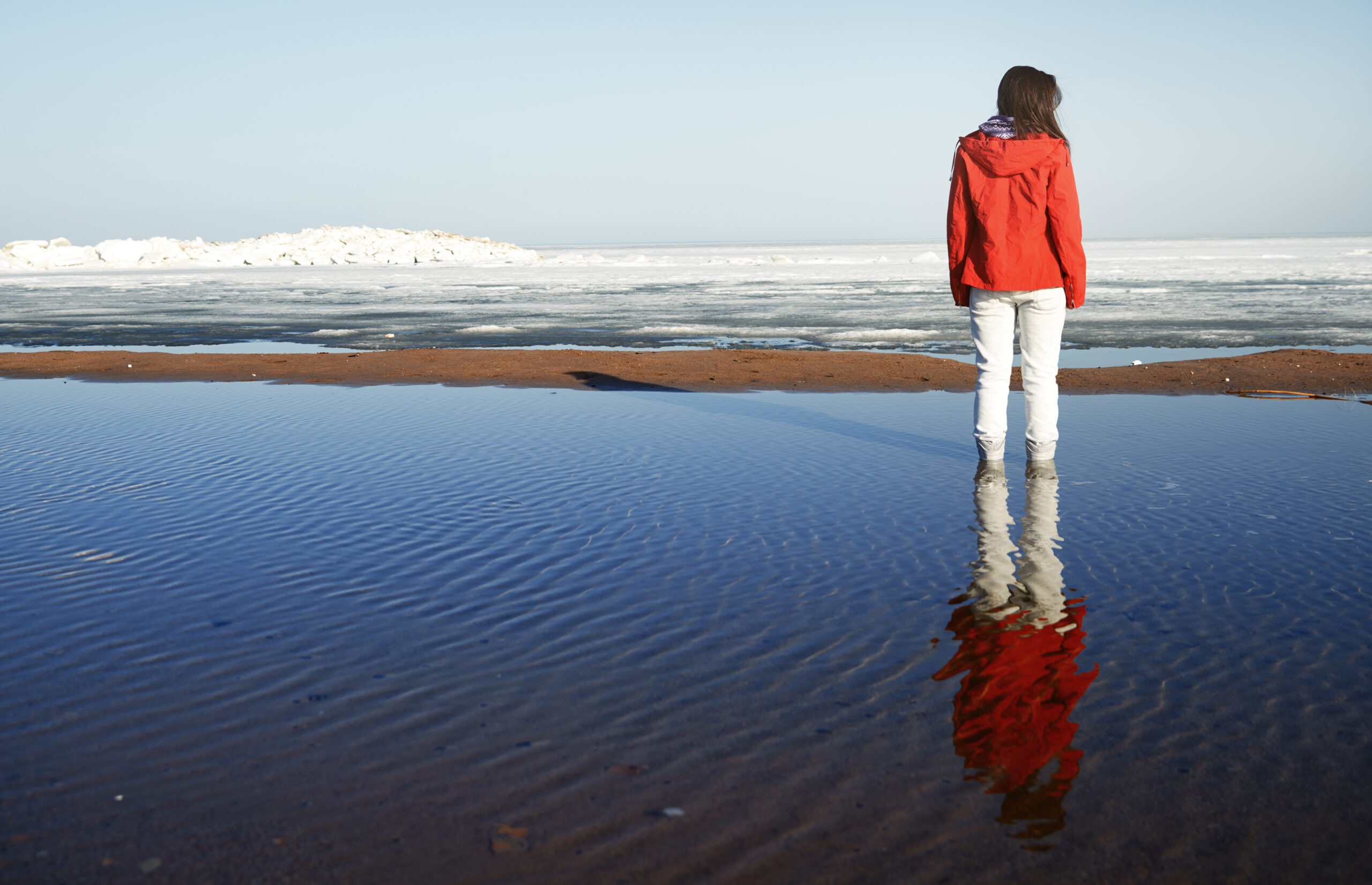 Young adult woman outdoors enjoying icy landscape
