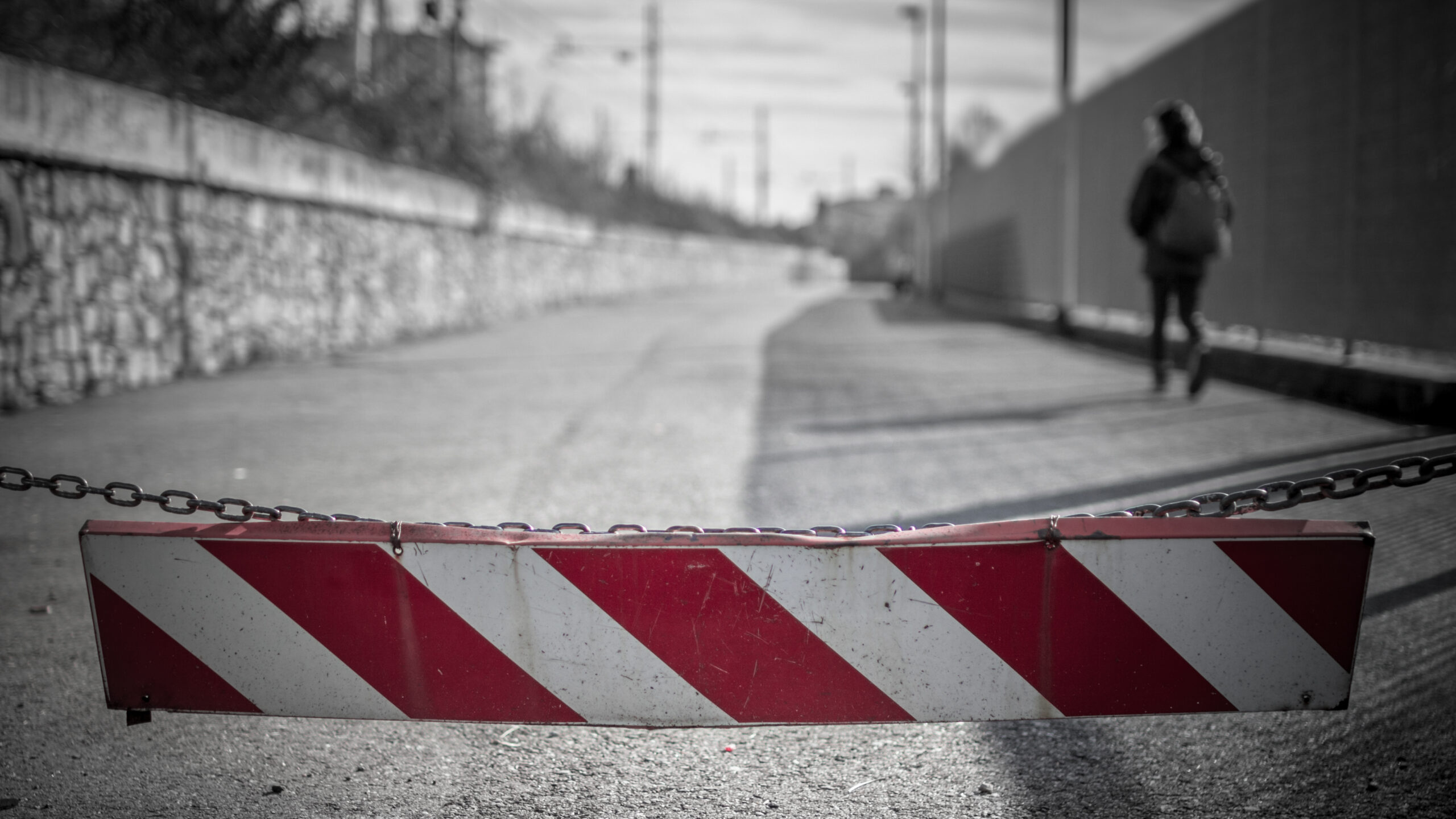 A girl walking down the street, toward the school.