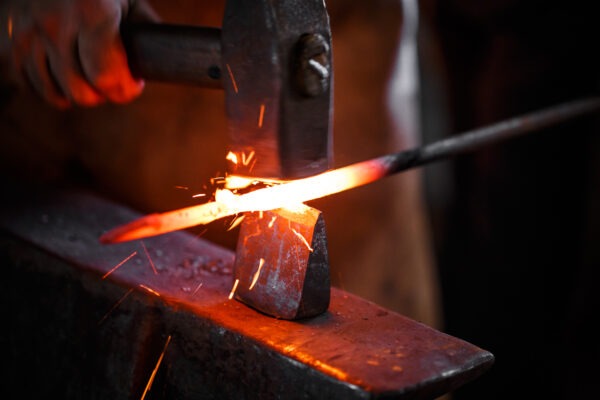 The hands of a blacksmith at work in the smithy