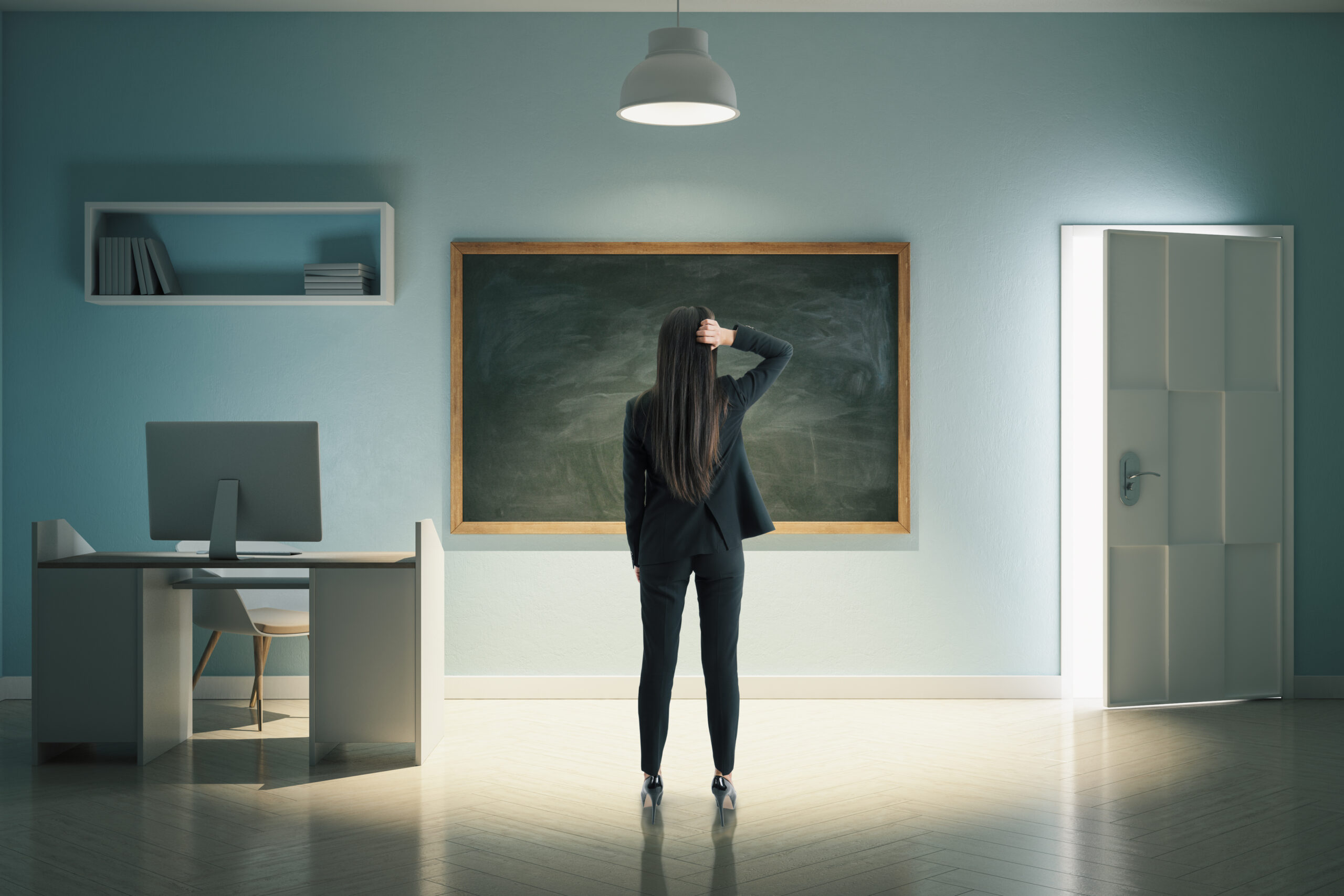 Businesswoman standing in home office with computer.